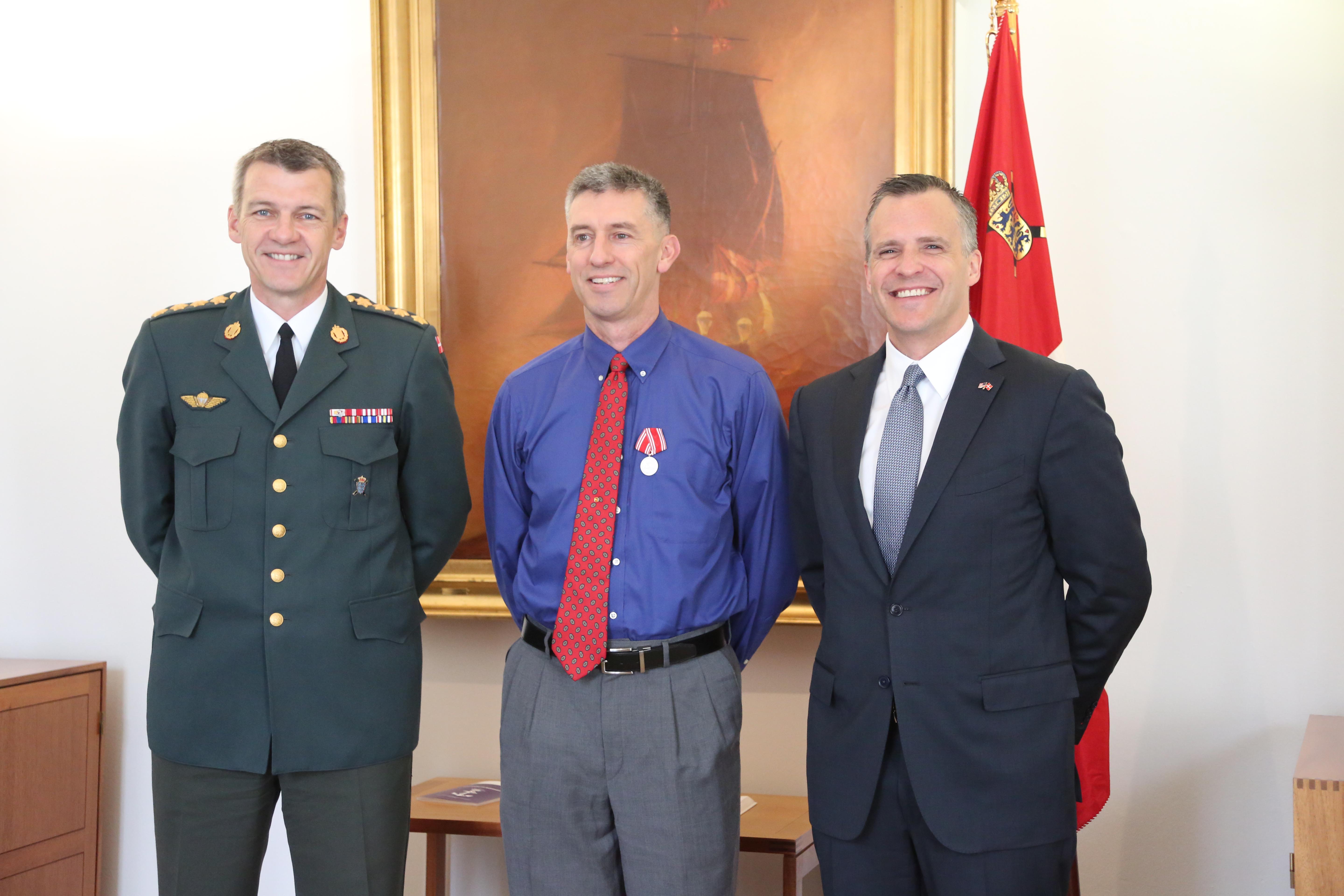 CAPTION:  Capt. Bradley Grimm, center,Texas Army National Guard, receives the Danish Defense Medal for Special Meritorious Efforts by Danish Defense Gen. Peter Bartram, left, and American ambassador to Denmark Rufus Gifford, right, at a ceremony held in Denmark, April 19, 2016.  Grimm was instrumental in foiling a terrorist plot to bomb a Danish school and assisted Danish security forces in making an arrest. (Danish Military photo by Sune Wadskjær/Released)